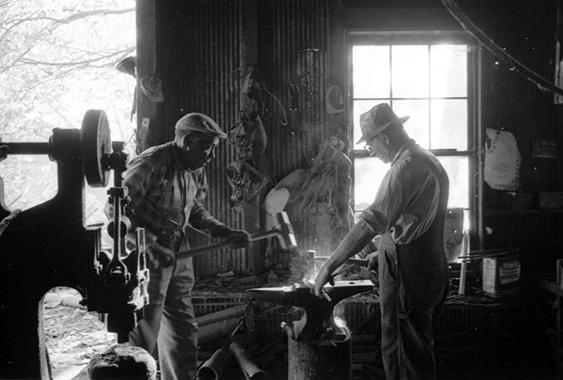 Blacksmith and helper
